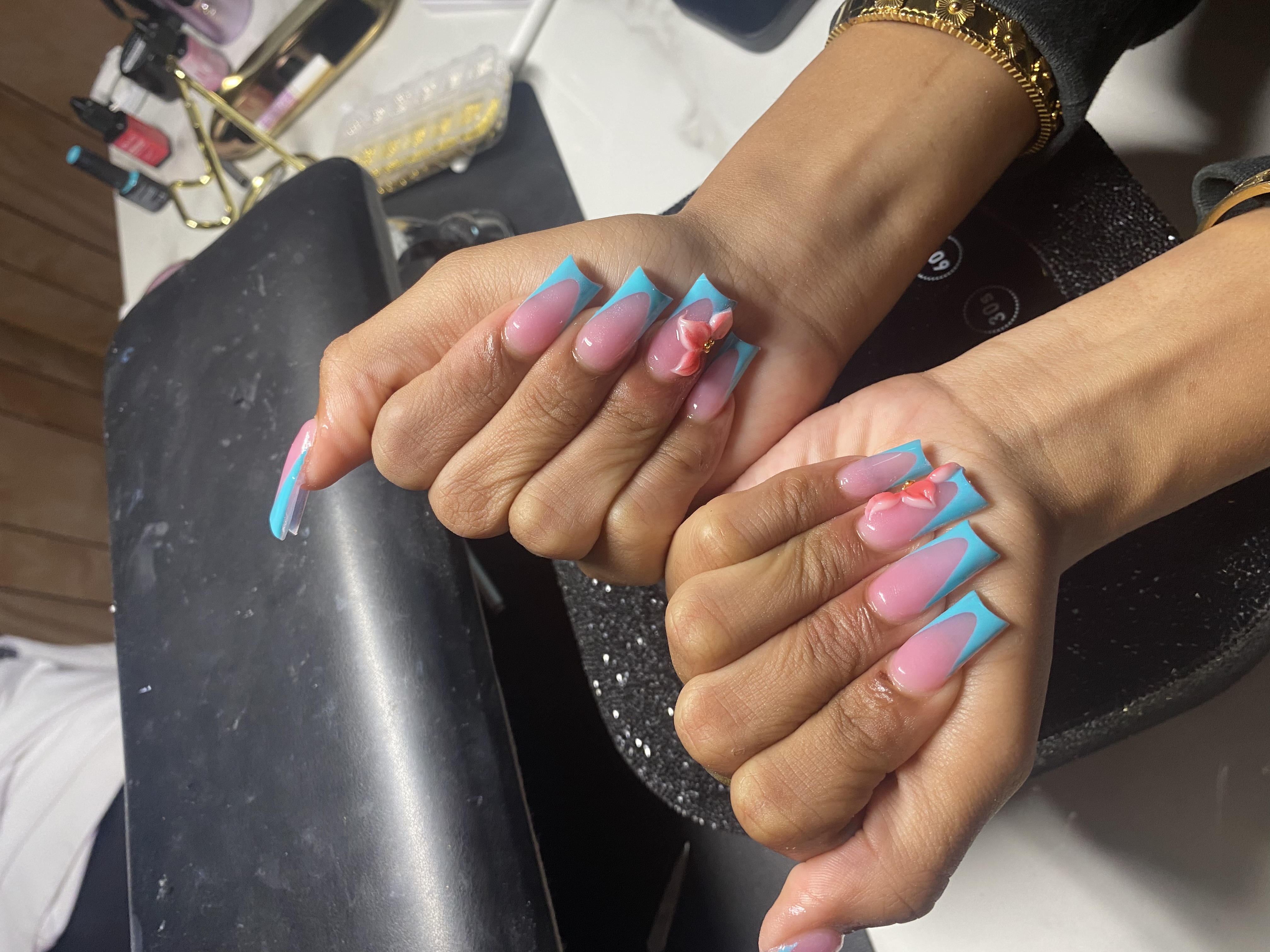 Blue French tip nails with 3D pink flower